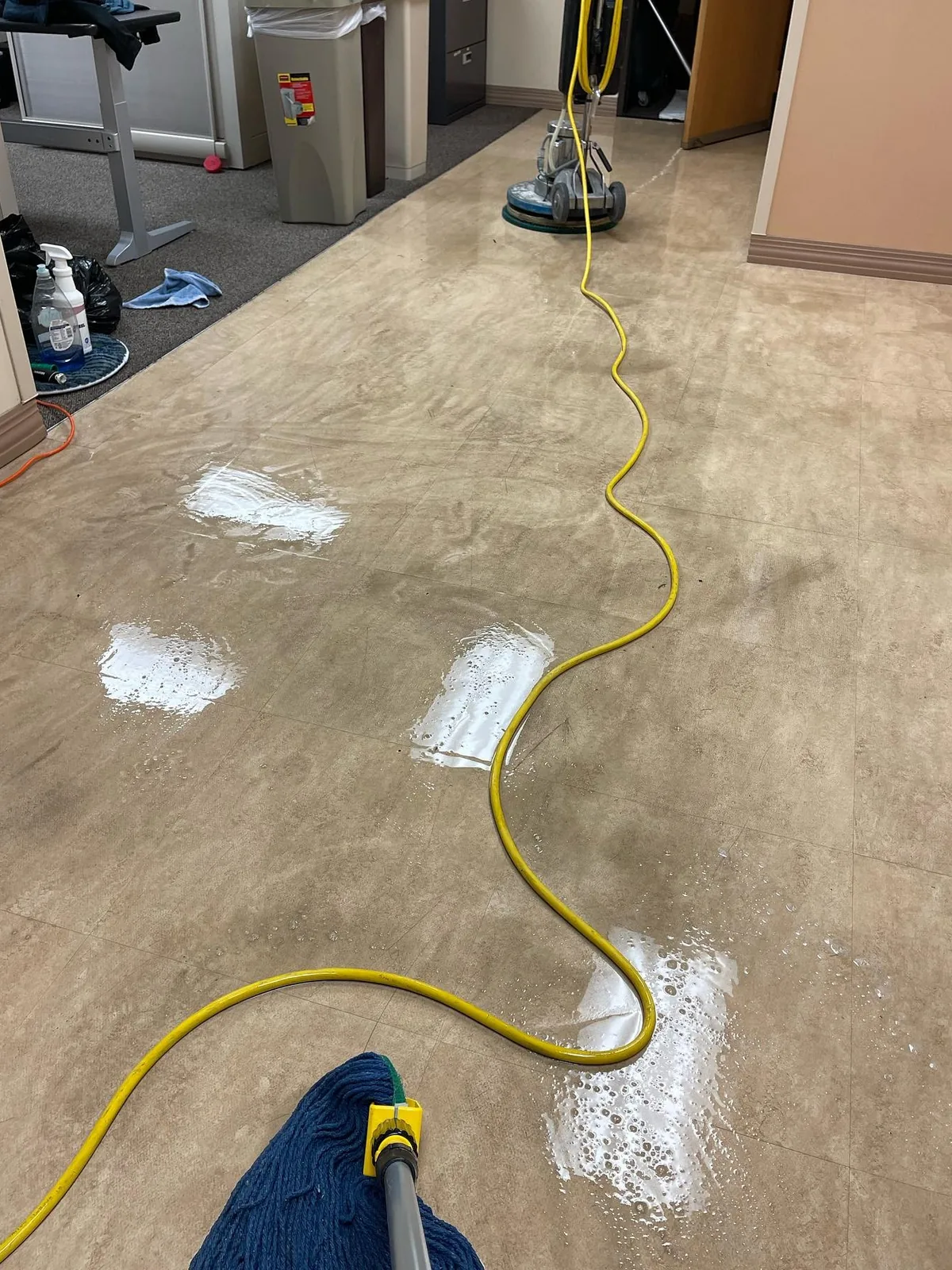 Floor machine stripping wax from a terrazzo floor