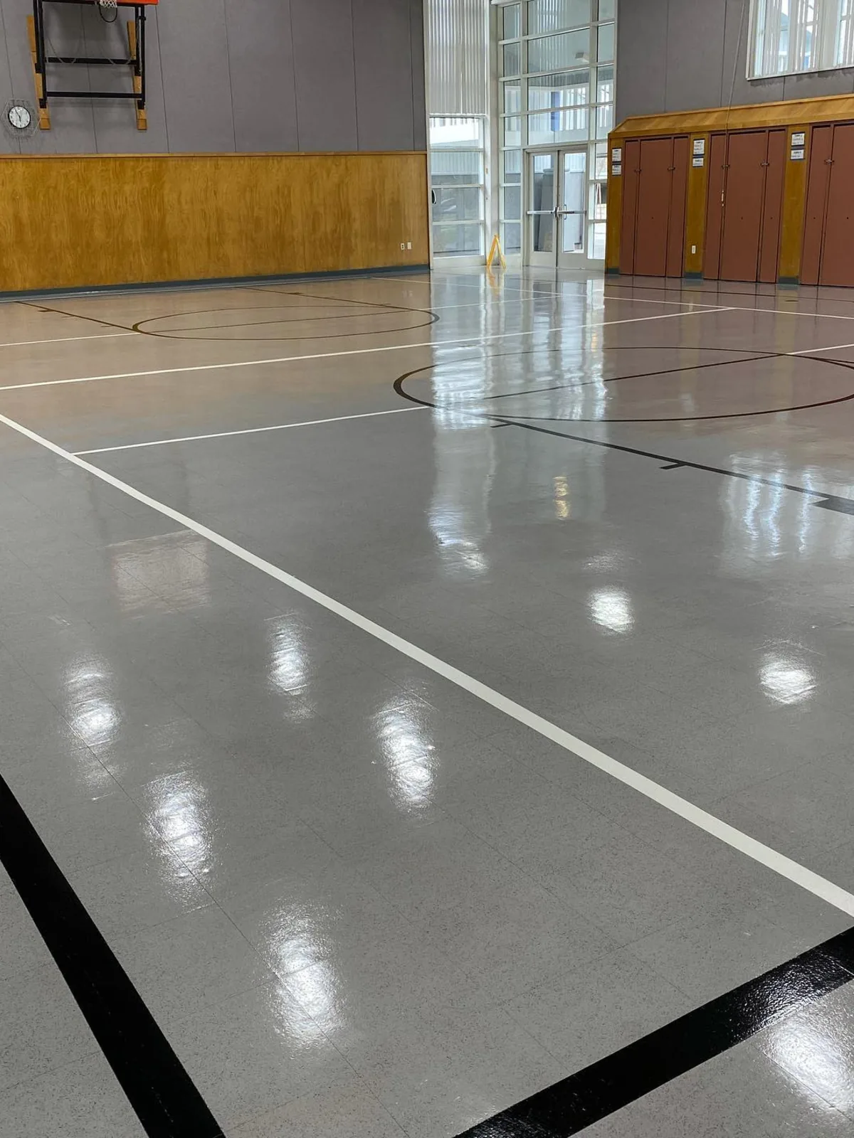 Gym floor stripped and waxed to a high gloss