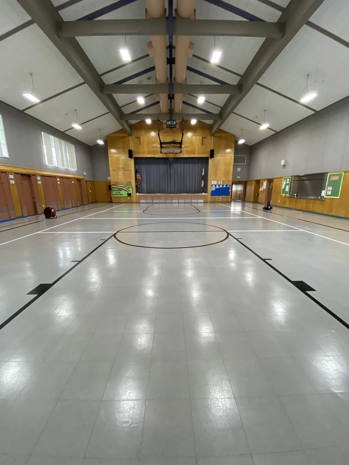 Polished gymnasium floor with painted court lines
