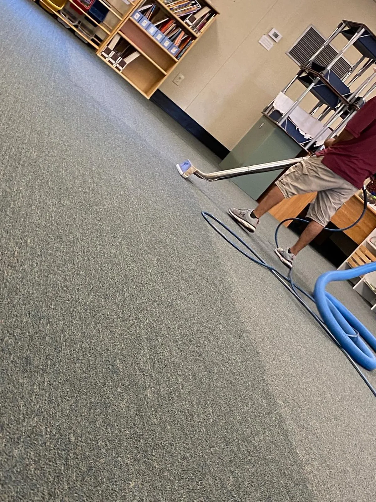 Steam carpet cleaning wand on commercial carpet